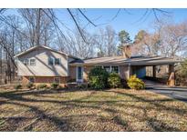 Charming split-level home featuring brick accents, vinyl siding, a welcoming front porch and covered carport at 8080 Monbo Rd, Catawba, NC 28609
