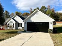 Charming one-story home with a spacious driveway and attached two-car garage at 9513 Isaac Hunter Dr, Charlotte, NC 28214