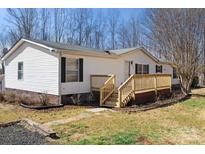 Charming single-story home with a welcoming front porch and well-maintained landscaping at 109 Fish Hill Dr, Statesville, NC 28677