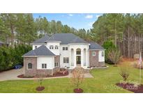Stunning two-story home with lush landscaping, stone accents, and a grand entryway at 133 Crooked Branch Way, Troutman, NC 28166