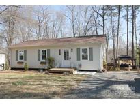 Charming single-story home with neutral siding, green shutters, and a welcoming front entrance at 1420 Columbus St, Albemarle, NC 28001
