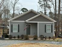 Charming single-story home with gray siding, classic shutters, and a well-manicured lawn at 194 Hattaway Cir, Mount Gilead, NC 27306