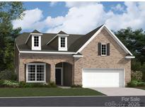 Beautiful, new brick home with a two-car garage and dormer windows provides great curb appeal at 2811 Morning Song Way, Lancaster, SC 29720