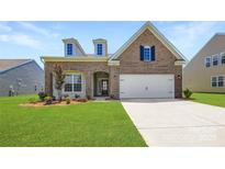 Charming brick home featuring a well-manicured lawn and a two-car garage, perfect for suburban living at 2811 Morning Song Way, Lancaster, SC 29720