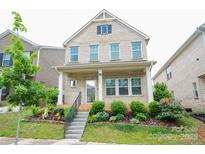 Charming two-story brick home featuring a well-manicured lawn and inviting front porch at 3207 Lisburn St, Charlotte, NC 28227