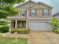 Charming two-story home with a two-car garage, neutral siding, and eye-catching red shutters at 3627 Alexander Forest Dr, Charlotte, NC 28269