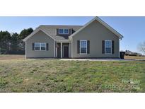 Charming single-Gathering home with neutral siding, a dormer, and well-maintained lawn at 4017 Avis Way, Monroe, NC 28110