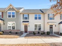 Charming townhome with beautiful curb appeal, manicured landscaping, and inviting front porch at 4107 Audubon Park Dr, Charlotte, NC 28217