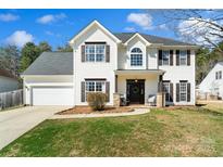 Charming two-story home featuring a well-manicured lawn and a two-car garage at 119 Nims Spring Dr, Fort Mill, SC 29715