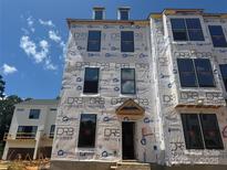 New construction exterior shows great potential, with large windows and modern design elements, ready for customization at 15344 Ballancroft Pkwy # 14, Charlotte, NC 28277