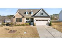 Charming home with a combination of brick and siding, complemented by a well-manicured front yard at 16617 Cozy Cove Rd, Charlotte, NC 28278