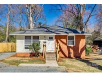 Charming single-story home with brick and siding, featuring a well-manicured lawn and inviting entrance at 2123 Purser Dr, Charlotte, NC 28215