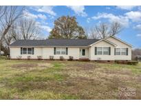 Charming single-story home featuring vinyl siding, a well-maintained lawn, and beautiful landscaping at 24697 Ramsey Dr, Albemarle, NC 28001