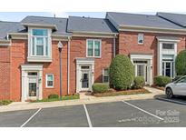 Charming brick townhome with well-maintained landscaping and designated parking spaces at 2658 Dilworth Heights Ln, Charlotte, NC 28209