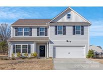 Charming two-story home featuring light gray siding, black shutters, and a well-maintained front yard at 3010 Beacon Ave # 86, Monroe, NC 28110