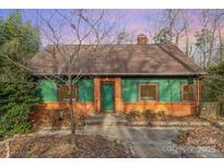 Charming exterior of a two-story home with a brick foundation and green trim around the windows and a green front door at 335 Summit Se Ct, Concord, NC 28025