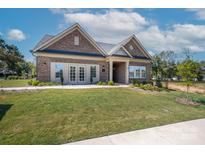 Charming brick home with a well-manicured lawn, beautiful landscaping, and inviting curb appeal at 413 Newstyle Way # 5, Cramerton, NC 28056