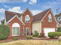 Charming brick home features manicured landscaping, a two-car garage, and inviting curb appeal at 9726 Woodend Ct, Charlotte, NC 28277