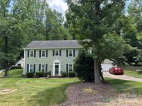 Charming two-story home with green siding, dark shutters, and well-manicured lawn at 1919 Windlock Dr, Charlotte, NC 28270