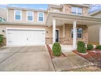 Charming two-story home with a two-car garage and inviting front porch, showcasing a well-maintained exterior and landscaping at 2679 Southern Trace Dr, Waxhaw, NC 28173