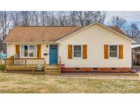 Charming single-story home featuring a quaint front porch and a bright blue front door at 307 Walnut St, Clover, SC 29710