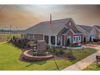 Beautiful single Gathering home boasting brick construction, manicured lawn, and inviting front porch at 3089 Founding Fathers Dr # 43, Gastonia, NC 28056