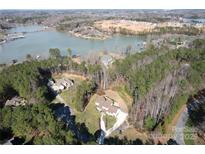 Beautiful aerial view of the lakeside house, showing the trees surrounding the property at 4616 Gold Finch Dr, Denver, NC 28037