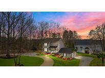 Stunning two-story home boasts lush landscaping, a charming porch, and a lakeside view at 520 Mainsail Rd, Salisbury, NC 28146