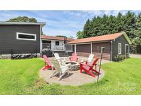 Cozy backyard fire pit area with seating, perfect for outdoor entertaining at 9808 Washam Potts Rd, Cornelius, NC 28031