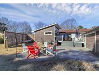 Cozy backyard features a fire pit and patio with outdoor seating perfect for gatherings and relaxation at 9808 Washam Potts Rd, Cornelius, NC 28031