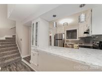 Well-lit kitchen featuring stainless steel appliances and white cabinets at 100 Willow Run Dr # 7, Gastonia, NC 28056