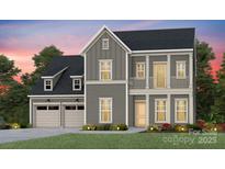 Charming two-story home with a welcoming front porch, attached two-car garage, and landscaped yard at 1049 Kinship Dr # 77, Lancaster, SC 29720