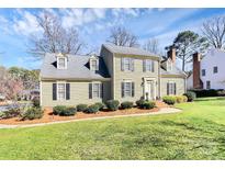 Charming two-story traditional home with a manicured lawn, mature trees, and neutral siding at 10501 South Hall Dr, Charlotte, NC 28270