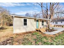 Cozy home exterior with a small porch and well-manicured landscaping at 1061 Gaither Nw Pl, Concord, NC 28027