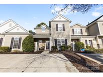 Charming townhome featuring a welcoming facade with neutral siding, dark shutters, and well-maintained landscaping at 11141 Lions Mane St, Charlotte, NC 28273