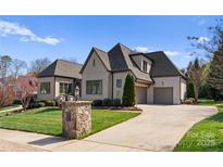 Beautiful home with a well-manicured lawn and a private driveway leading to a two-car garage at 19604 Olde Spring Ct, Cornelius, NC 28031