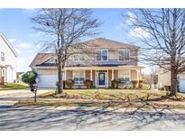Charming two-story home with a welcoming front porch, blue door, and well-maintained lawn at 3008 Semmes Ln, Indian Trail, NC 28079