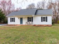 Welcoming single-story home boasting a covered porch, well-maintained yard, and classic curb appeal at 417 Columbus Ln, Monroe, NC 28110