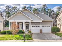 Charming single-story home with a two-car garage, well-manicured lawn, and inviting front porch at 565 Sugar Tree Dr, Rock Hill, SC 29732