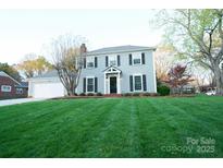 Charming two-story home with a well-manicured lawn, attached garage, and inviting front entrance at 5925 Carmel Station Ave, Charlotte, NC 28226