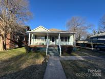 Charming single-story home with a welcoming front porch and well-maintained lawn at 128 Cromer St, Charlotte, NC 28208