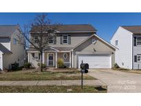 Charming two-story home featuring a well-manicured lawn and inviting front porch at 12915 Deaton Hill Dr, Charlotte, NC 28269