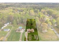 An aerial view showcasing the property's spacious lot and its surrounding tree coverage at 1335 Blacksnake Rd, Stanley, NC 28164