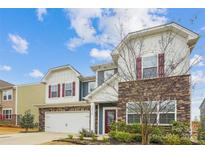 Charming two-story home featuring stone accents, a two-car garage, and a landscaped front yard at 15119 Oleander Dr, Charlotte, NC 28278