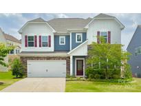 Charming two-story home with stone accents, white siding, and a well-maintained front yard at 15119 Oleander Dr, Charlotte, NC 28278