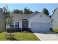 Charming single-story home featuring a two-car garage, stone accents, and a well-manicured front lawn at 1532 Doran Ter, Richburg, SC 29729