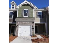 Charming two-story townhome with a one-car garage and stone accents at 3511 Nimbell Rd, Monroe, NC 28110