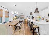 Bright, open kitchen with a large island, pendant lighting, and dining area at 3512 Auburn Curb Rd, Charlotte, NC 28217