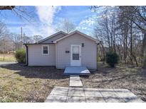 Charming single-story home featuring vinyl siding, a concrete path, and a well-manicured lawn at 501 S Hoyle St, Dallas, NC 28034