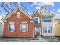 Charming brick and vinyl two-story home with colorful shutters and well-maintained landscaping at 558 Rough Hewn Ln, Rock Hill, SC 29730